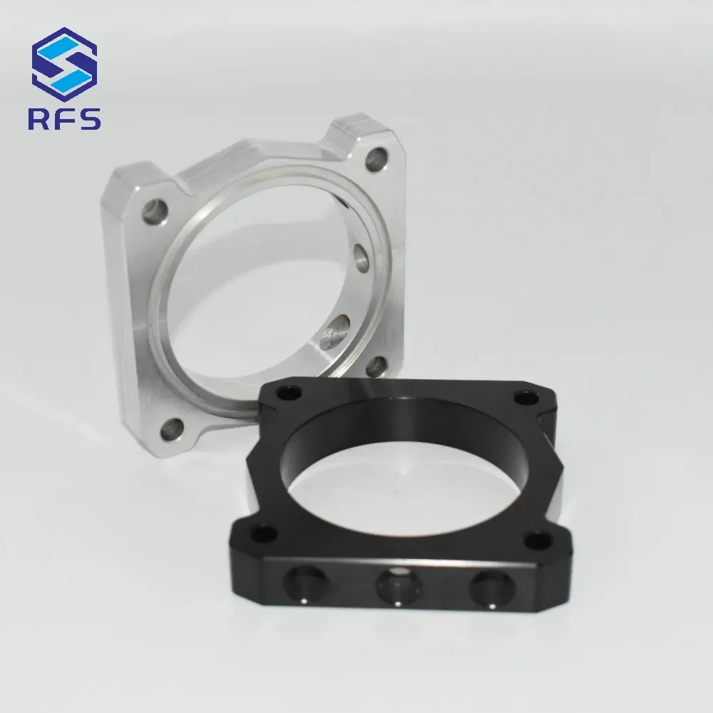 Precision CNC milled steel spacer pair shown in standing and flat orientations